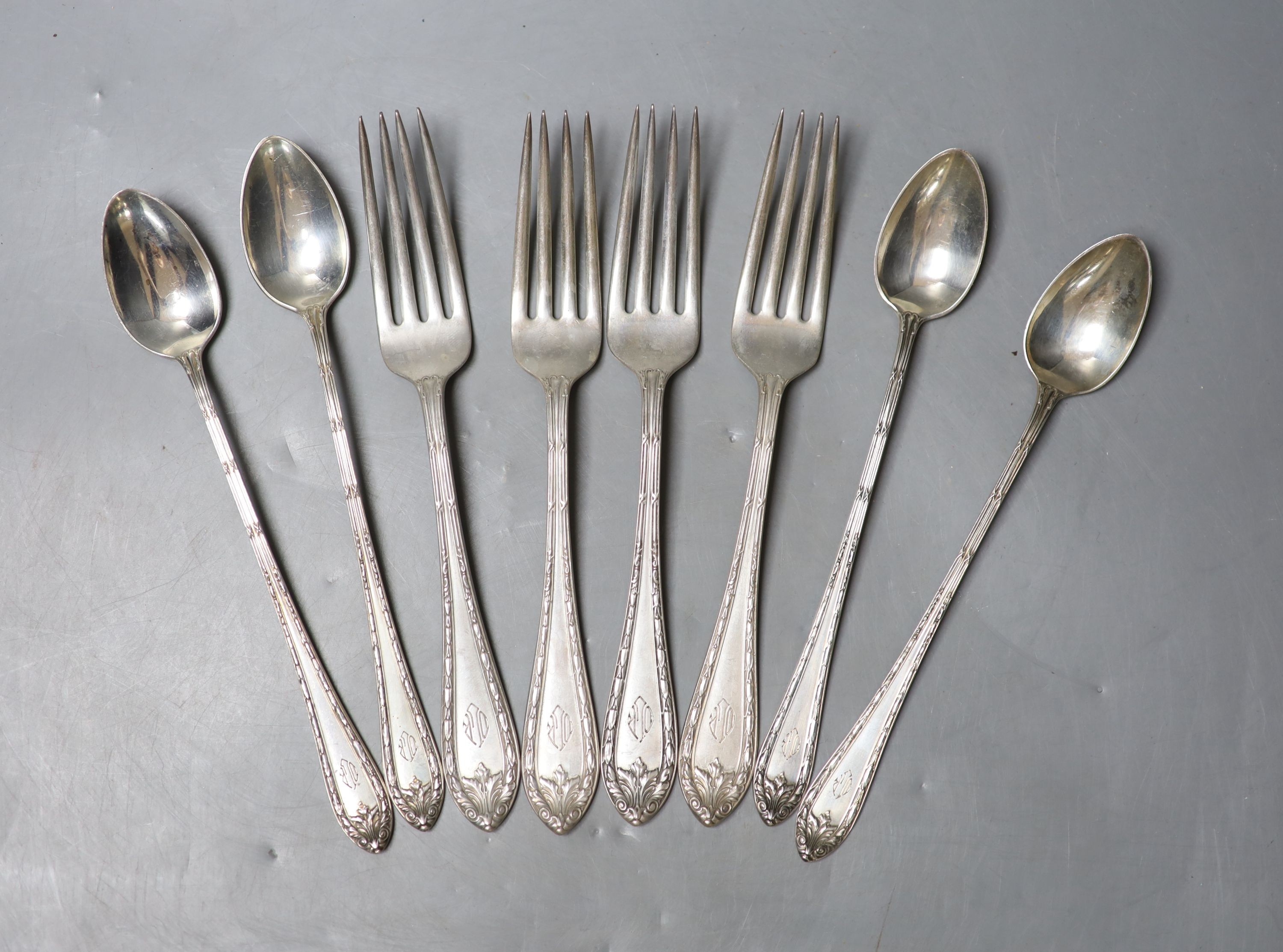 Four American sterling iced tea spoons, signed Cartier and a similar set of four table forks, 13oz.